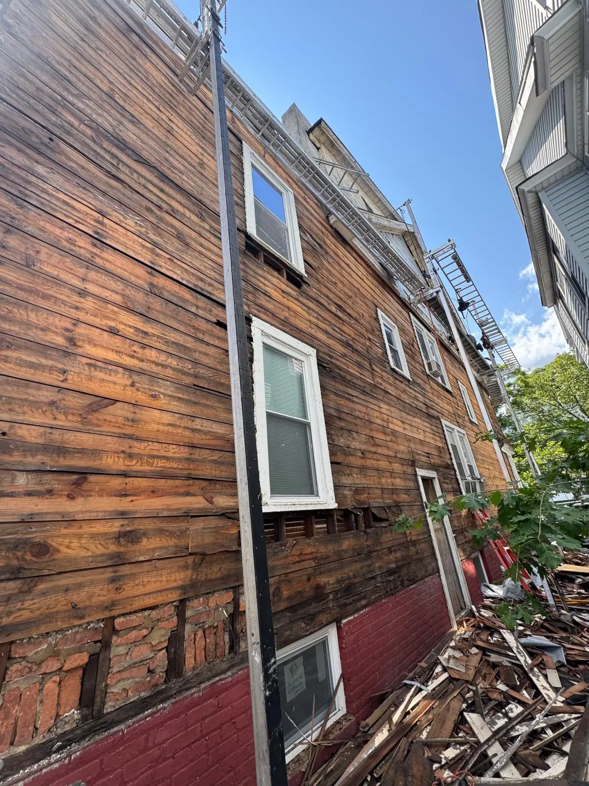 Worn siding before exterior remodeling in New Jersey